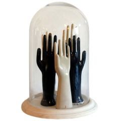 Old factory glove mold collection in a vintage dome