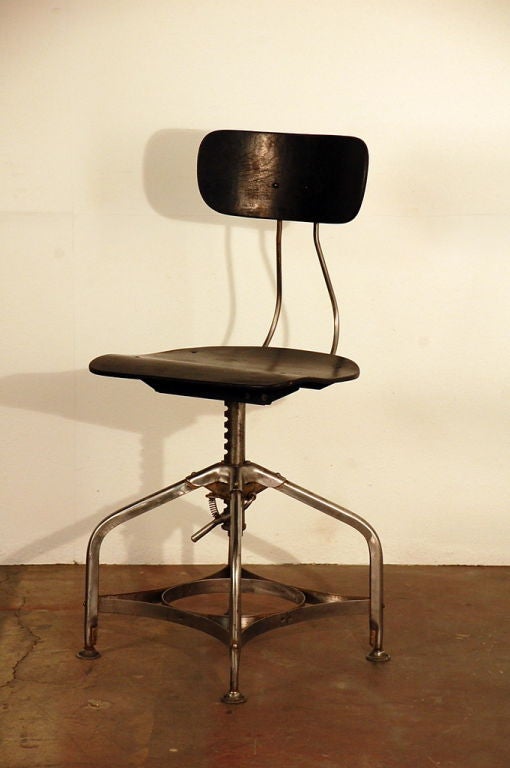 Polished steel and ebonized wood Toledo adjustable drafting stool.