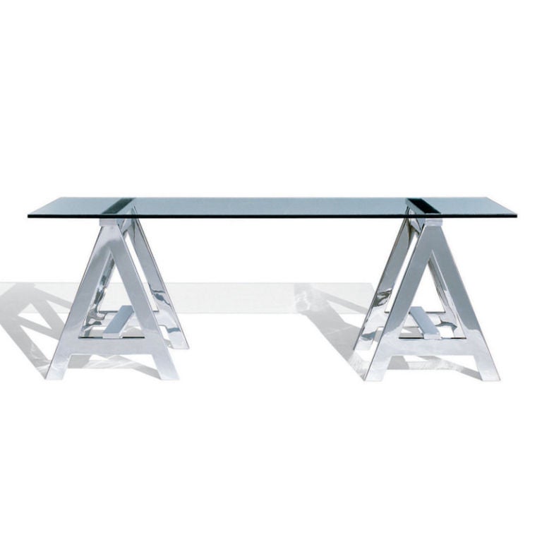 This sleek classic form has been updated with a modern sensibility by Ralph Lauren. Stainless steel sawhorse legs, polished to perfection, support a serene work surface crafted of clear glass.