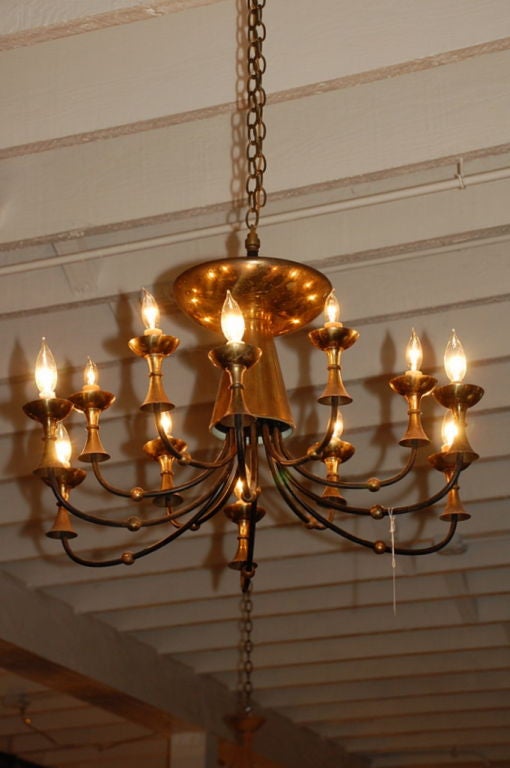 Large brass chandelier in the style of Paavo Tynell.