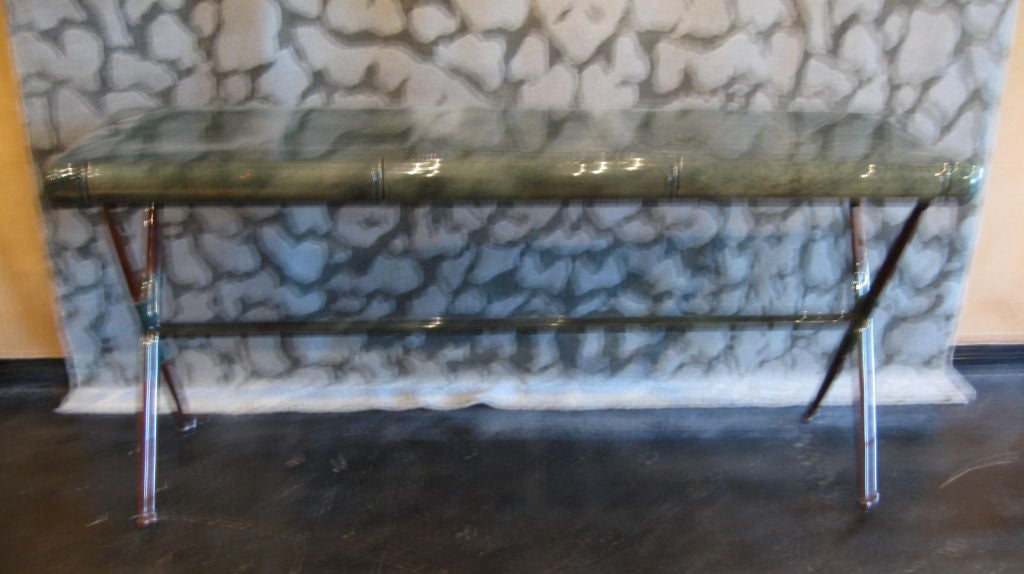 GREEN GOAT SKIN CONSOLE WITH THREE DRAWERS IN FRONT, X SHAPED BRASS LEGS WITH BALL FEET.