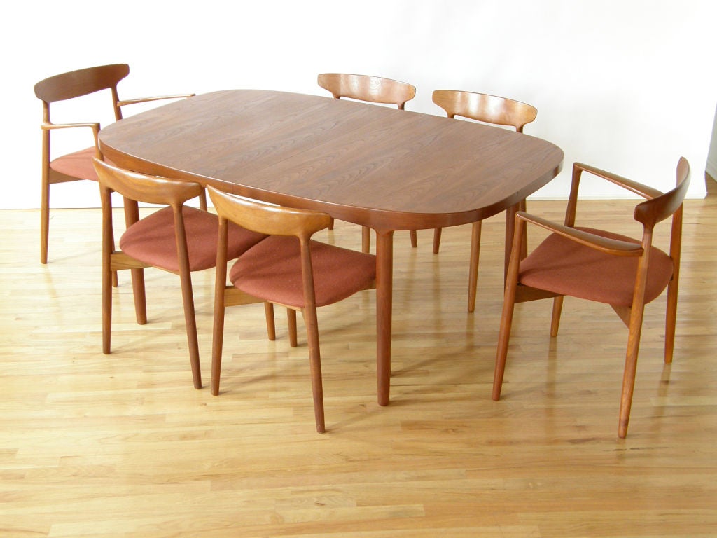Dining table and six chairs designed by Harry Ostergaard for Randers, Denmark.<br />
Table has 2 x 21 .75