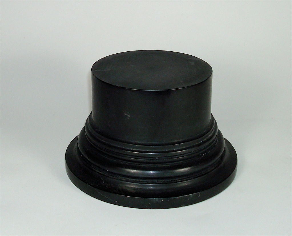 Sculpture of a column base in black marble from France.