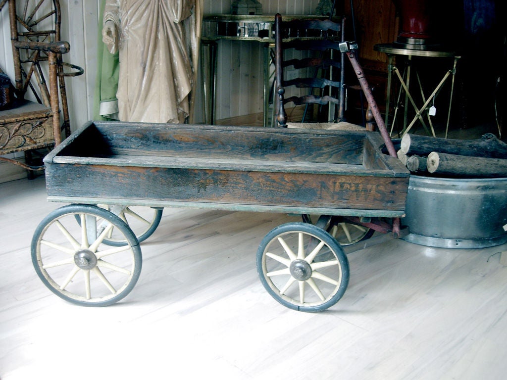 Charming late 19th century American paperboy's delivery wagon with original lettering.  Great display piece or coffee table.