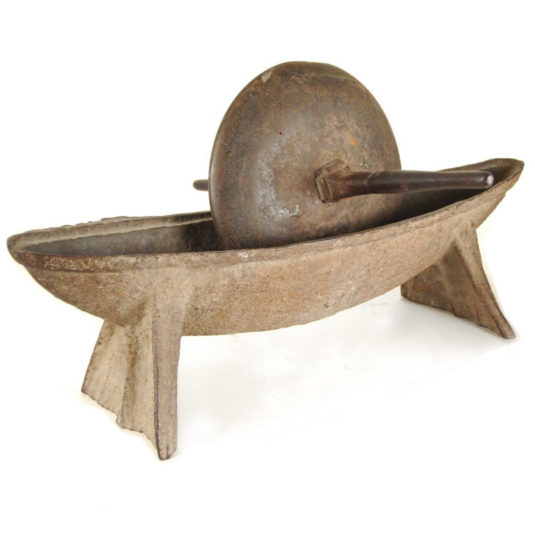 A 19th century iron rolling tea leaf grinder with elongated mortar used for crushing medicinal herbs and teas.<br />
<br />
Pagoda Red Collection #:  S004<br />
<br />
<br />
Keywords:  Mortar, pestle, Chinese, China, iron, sculpture, statue,