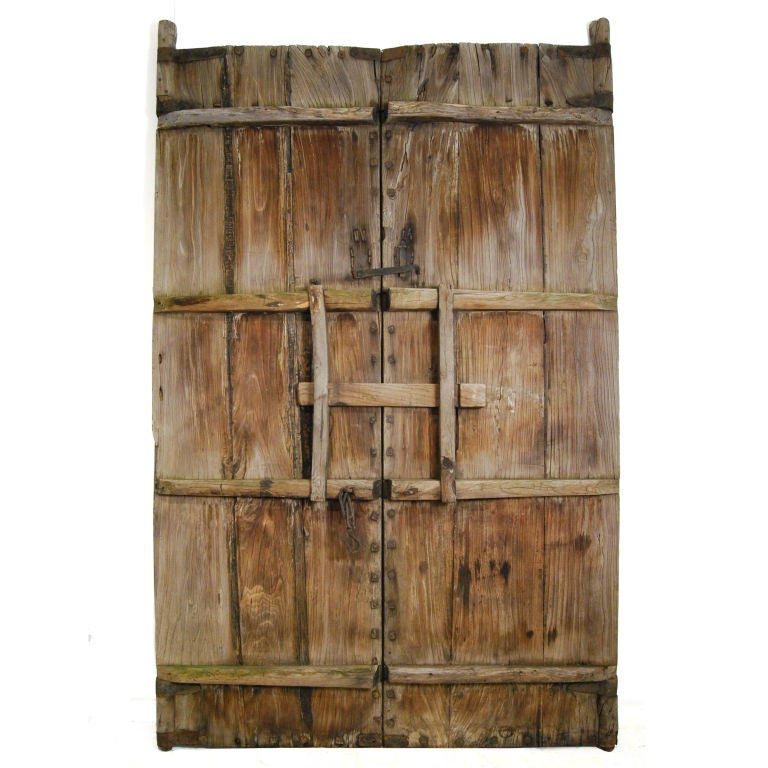 A pair of 19th century Chinese courtyard doors with iron hardware, studs, and original locks on reverse side.<br />
<br />
Pagoda Red Collection #:  S140<br />
<br />
<br />
Keywords:  Doors, closet, cupboard, cabinet, armoire