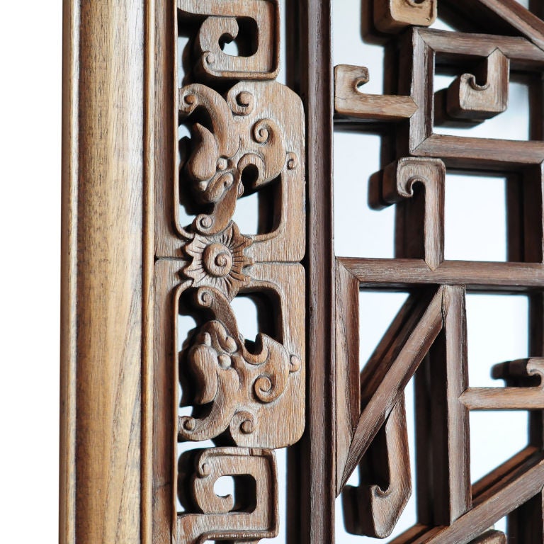 A pair of 19th century Chinese camphor wood window lattice panels with carved crooked dragon and phoenix motifs, backed with mirrors.<br />
<br />
Pagoda Red Collection #:  CAE103<br />
<br />
<br />
Keywords:  Mirror, panel, lattice, screen,