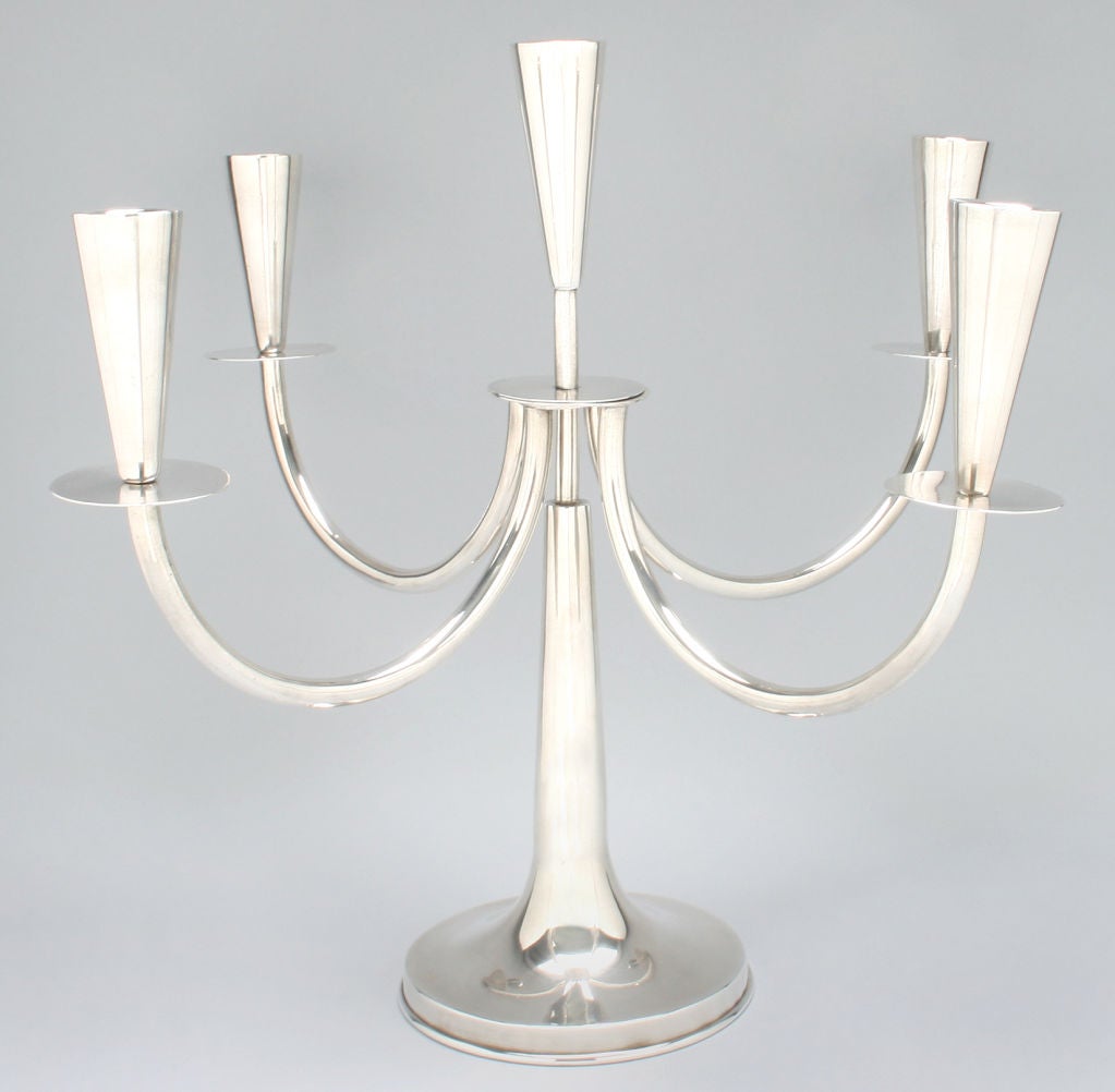 These are a wonderful pair of candelabra, substantial in size and weight. The candelabra are simple and elegant and would work in a variety of styles from Deco to Modern.
