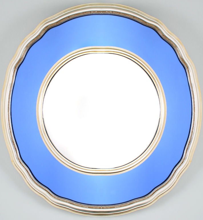 This unusual mirror is hand carved and silver leafed.  A blue mirror surrounds a central convex mirror.