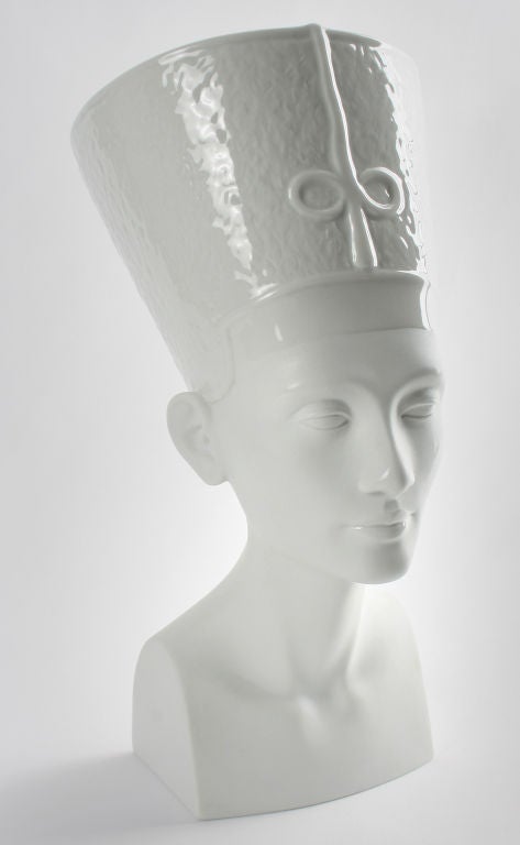 This is a finely modeled bust of The Egyptian Queen Nefertiti.  She was hailed as the most beautiful woman in the world. She is highlighted by a clear glaze on her lips and headress.