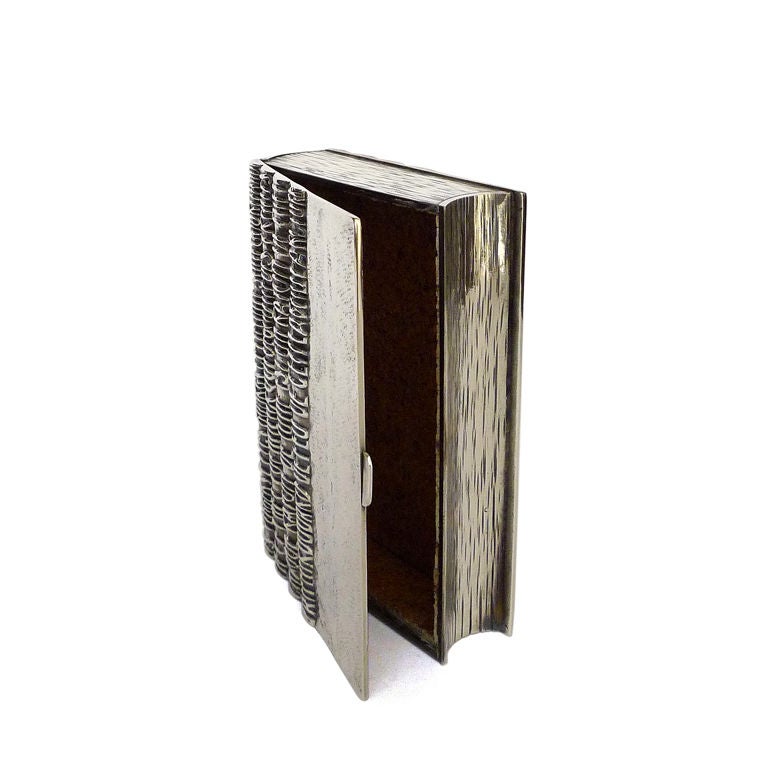 A silvered bronze box in the form of a book, inspired by Guillaume Apollinaire's 