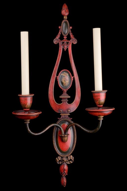 Pair of Chinois style sconces, chinois medallions, painted red and black acorn finial on top, ribbon on bottom. by EF Caldwell of New York, circa 1900