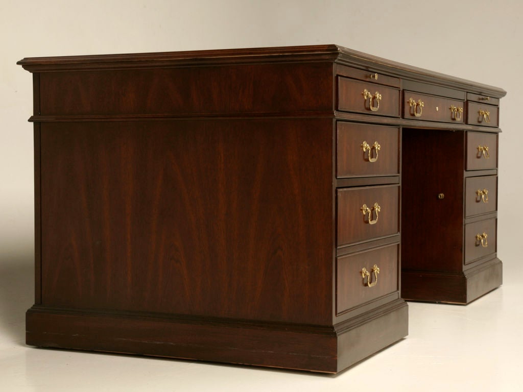 Exquisite vintage American solid wood executive desk with an absolutely stunning 3 panel crotch/flame mahogany top. The functionality of this fine desk is superb, it has 7 drawers (2 of which are locking files), all of which glide smoothly on metal
