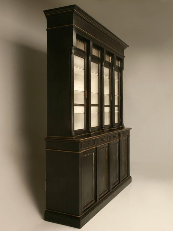 Magnificent antique French Napoleon III 8 over 8 bibliotheque/china cabinet. Finished in black with gold trim, this fluted beauty will take your breath away. It's contrasting winter white interior showcases most any collection, be it crystal, china,