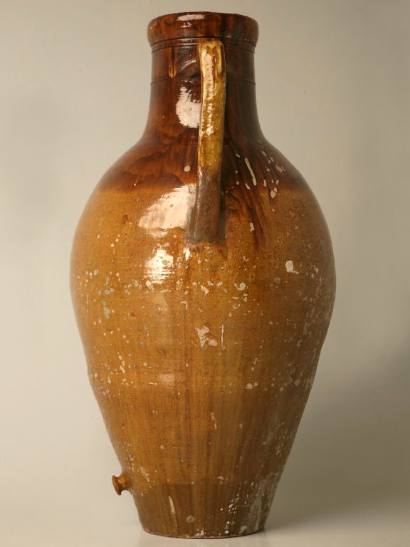 Antique Italian enameled terracotta olive oil jar from Puglia region of Italy. Beautiful earthenware vessels were used 75 to 150 years ago to store grains, olives, oils, and prepared foods. Often buried to preserve their contents at cooler