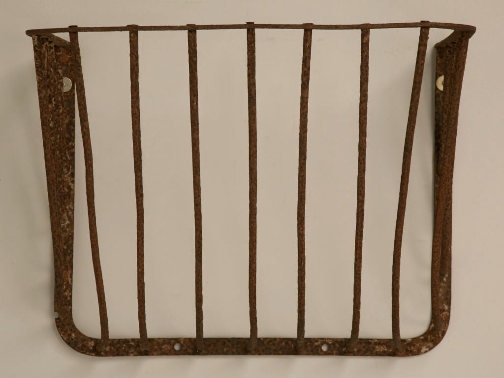 Remarkable antique English hand-wrought iron hay rack. Our ingenious buyer spotted this gem and thought it would be amazing as a rustic console by adding a top. We think she hit the nail on the head, by adding a stone, rustic hand hewn timber, or