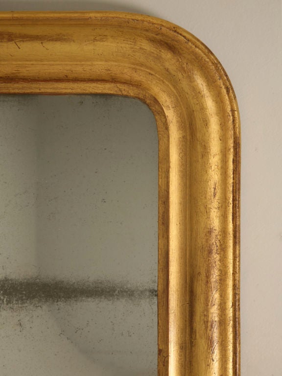 Antique French Louis Philippe mirror with a 23-karat gilded frame and its original sugared glass. Absolutely dynamite, this fantastic mirror would compliment most any decor, use it in the master bath, a wonderful living room, or over a fantastic