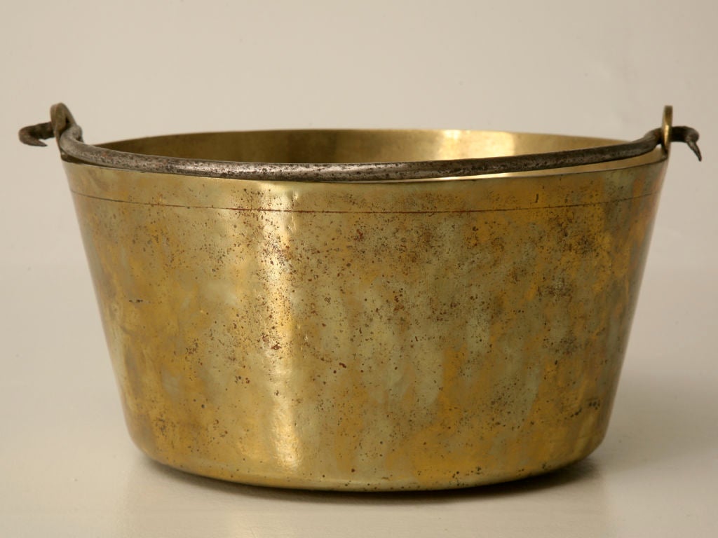 Awesome handmade antique English brass cauldron retaining it's original hand-wrought iron bail handle. Perfect for kindling next to the fire, magazines next to a favorite chair, or drill the bottom and have your very own one-of-a-kind vessel sink.