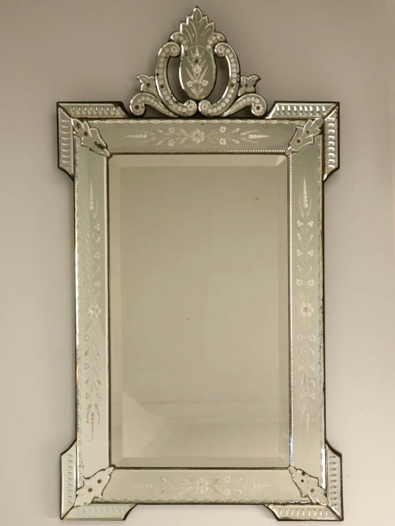 Breathtaking vintage Italian venetian mirror with beautiful deeply cut and etched decorations. Wonderful utilized a number of places, be it the entryhall welcoming you and your guests, hanging over a desk or table making a delightful vanity or