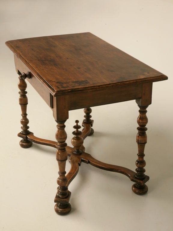 Outstanding antique French walnut, 2 board topped writing table with drawer. This table is fantastic, with a pleasing time-worn patina, showing centuries of use. With it's exquisite turned legs, X-form cross stretcher with finial, and full width