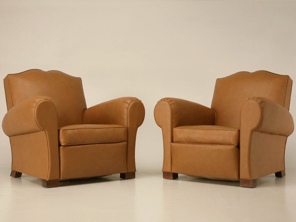 Extra clean pair of vintage French moustache back club chairs. These chairs are fabulous, with all the style, charm and character you would expect. Perfect in a game-room for lounging with friends, in the family room for watching TV, or in the