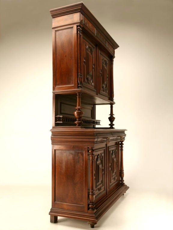 Spectacular antique French Henri II solid walnut hunt cabinet with magnificent carvings throughout. Four gem-cut carved doors open to reveal shelving to hold a plethora of goodies. A recessed serving area with a small gallery is supported by turned
