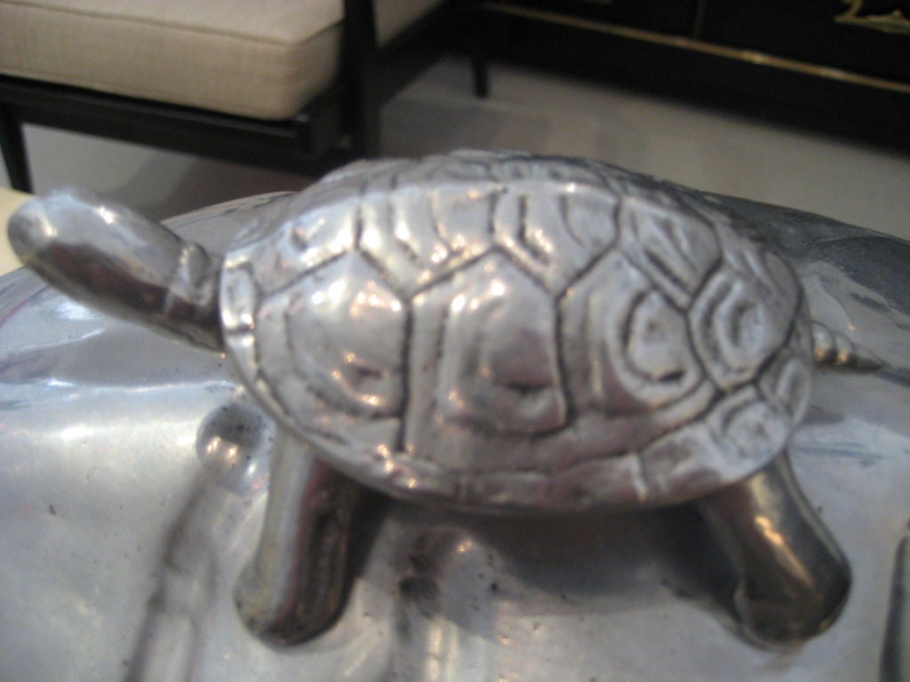 Very large aluminum turtle carving station by Arthur Court. The baby turtle on top serves as the handle. The interior of the piece has a wood plateau for carving.