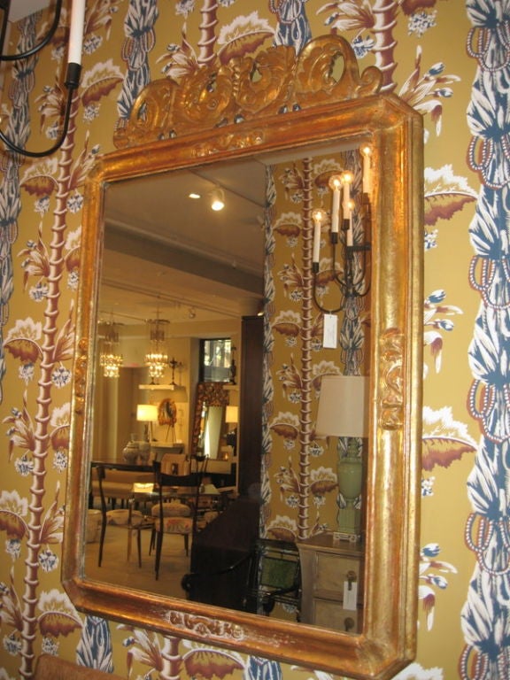 19th Century Italian Gilt over Wood Mirror with Scroll work on top.