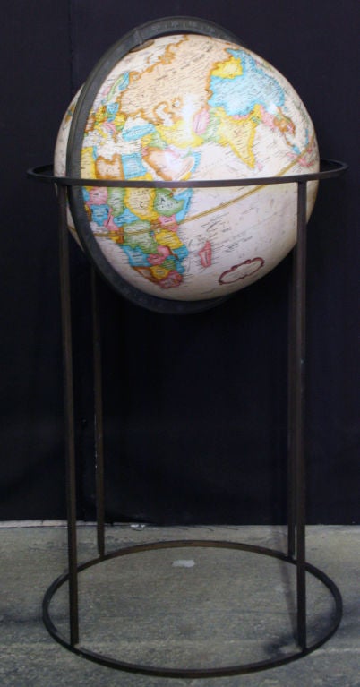 A late 1960's floor standing globe by Paul McCobb on a minimal open form frame of square bronze tubing.