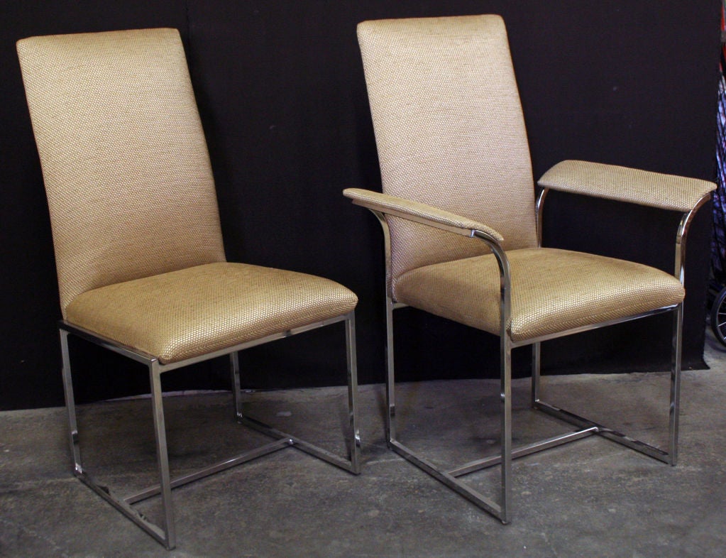 A group of twelve high back dining chairs by Milo Baughman new textured oatmeal colored fabric with four side chairs on heavy square tubing chromed steel bases and two armchairs on which the upholstered arms rise and flare seamlessly from the