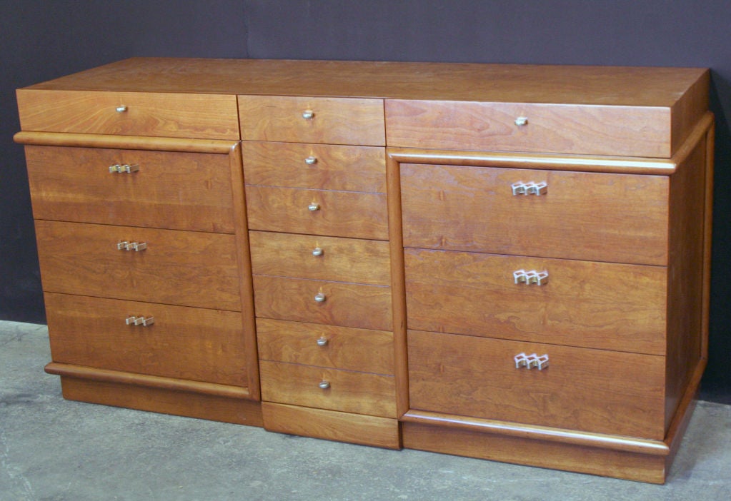 A unique and beautifully grained twelve drawer dresser in rare Bubinga wood showing a combination of styles from the crossover post war era between forties and classical 