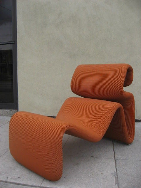 Body built ergonomic chair. Steel frame covered with Pullmaflex spring backing and foam with chrome glides.<br />
Recovered with an orange and black striped stretched fabric