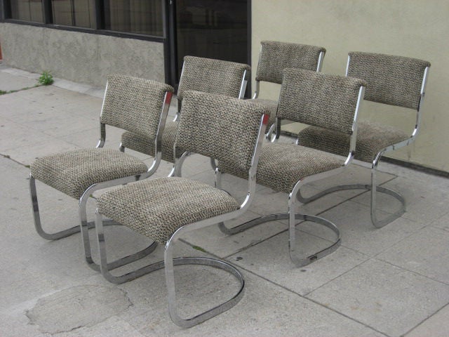 Cantilevered chrome chairs recovered in a black and white chenille.