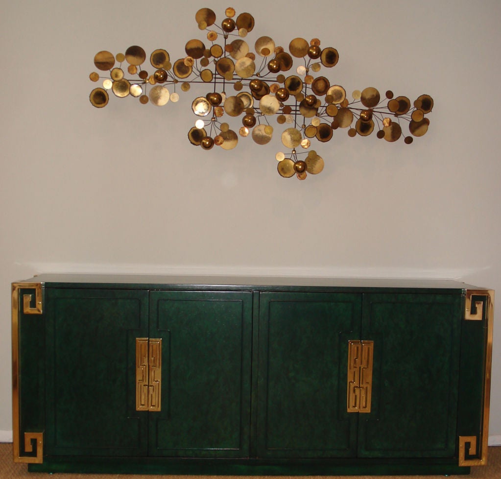 Spectacular emerald stained on burl elm credenza. Brass plated greek-key accents. Newly restored.