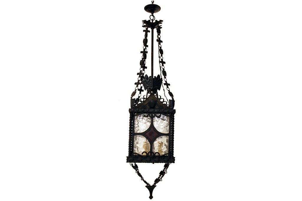 hanging from its original canopy from a centered iron rod and also having decorative 