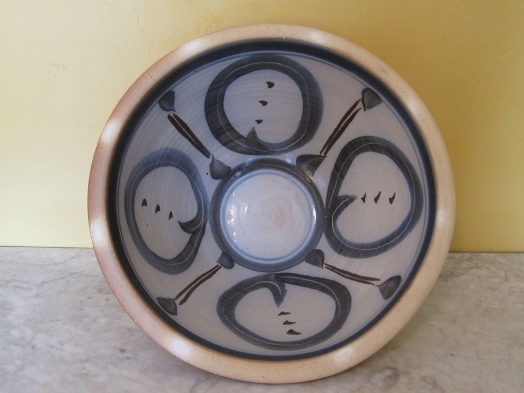 This is a massive bowl by North Carolina potter Mark Hewitt. There is an Asian feeling about the glazed decoration that fills the center.  Along the outside rim of the bowl are white dots where the glaze was intentionally left off. This is