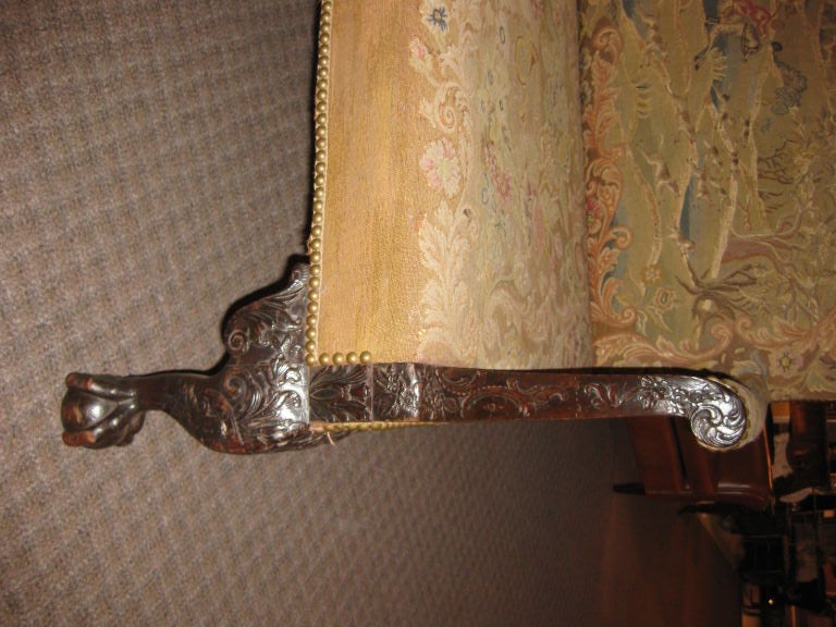 This sofa has carved knees and feet. The tapestry is of a French hunt scene. The back is velvet