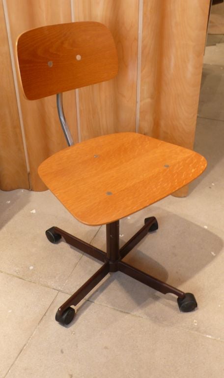 Iconic Kevi desk chair by Danish designer Jorgen Rasmussen, with adjustable plywood seat and back and proprietary 1965 wheel design.  Original Kevi production, c. 1970.<br />
Retains original label and impressed mark on base.  Excellent original
