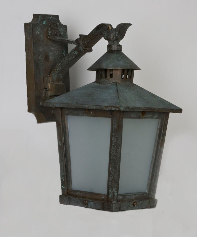 A pair of antique bronze wall lanterns