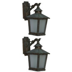 A pair of antique bronze wall lanterns