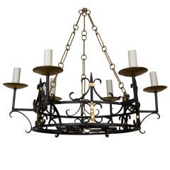 An antique wrought iron ring chandelier