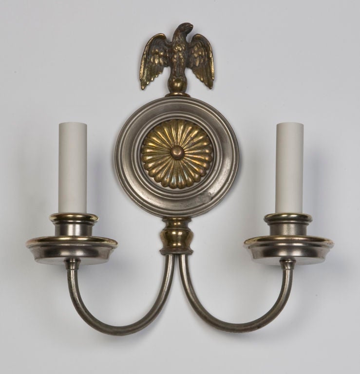 AIS2641

A pair of antique double-light sconces in their original nickel and brass finish. Having eagles surmounting the gadrooned-rosette backplates. Signed by the New York maker E. F. Caldwell.

Backplate: 9 3/8