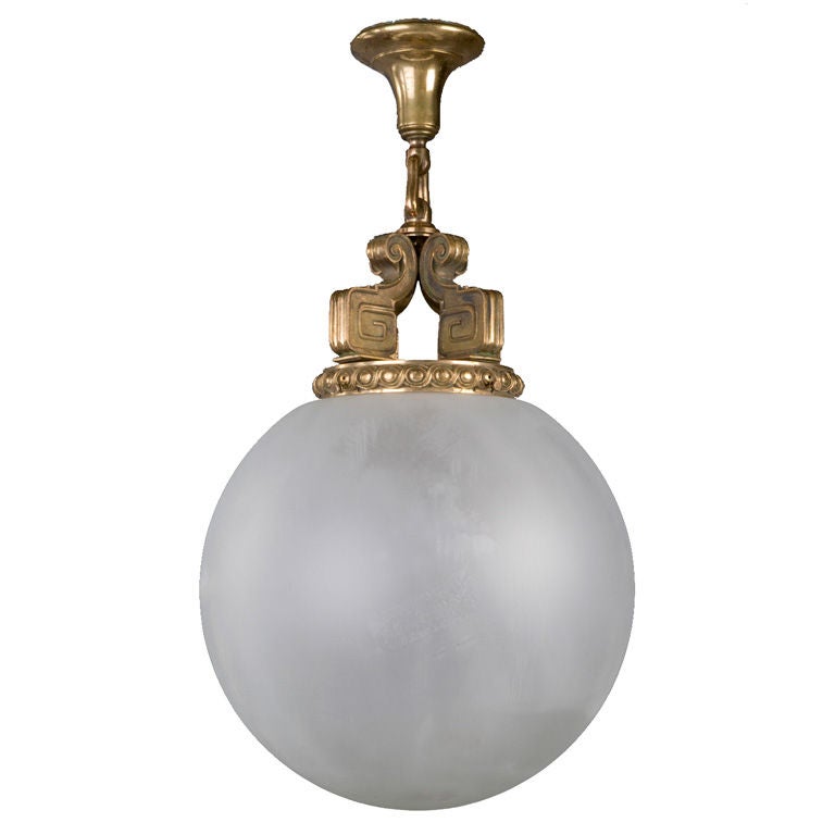 An antique bronze and frosted glass pendant