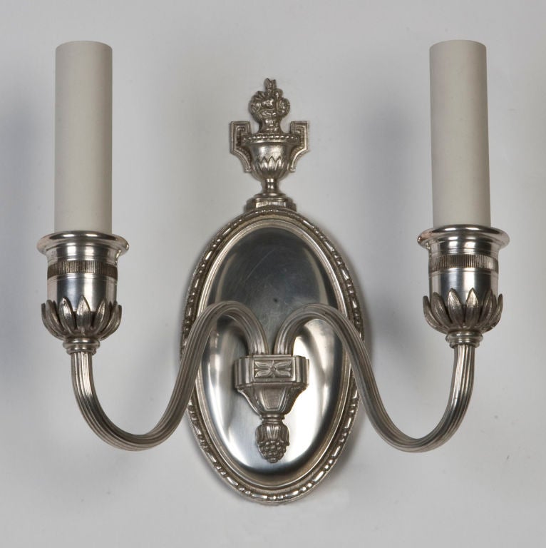 A pair of antique silver sconces