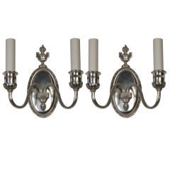 A pair of antique silver sconces