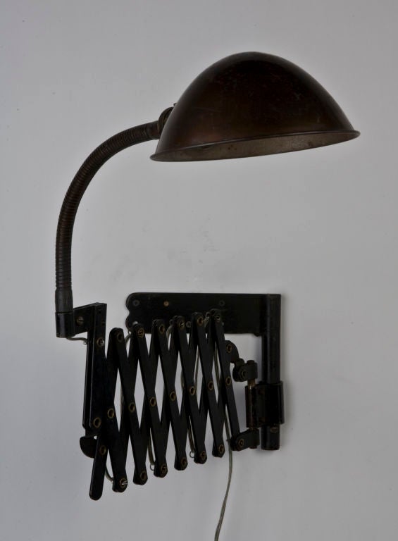 An antique blackened steel scissor light