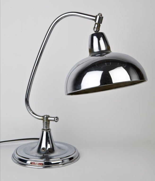ATL1813

A vintage chrome dome-shaded desk lamp with a C-shaped arm and a broad base. Signed by Chicago maker Apollo Electric Co.

Overall height: 20