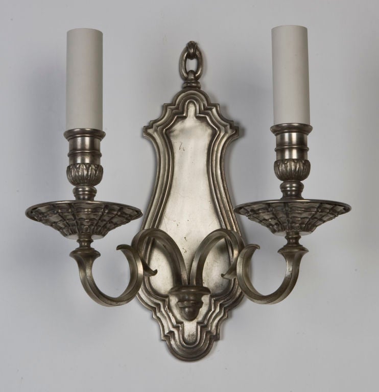 An antique double light silver sconce
