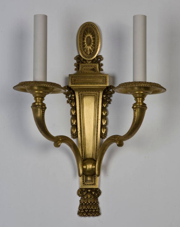 An antique gilded Caldwell sconce