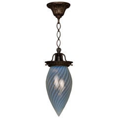 A hand-blown swirled opaline glass pendant